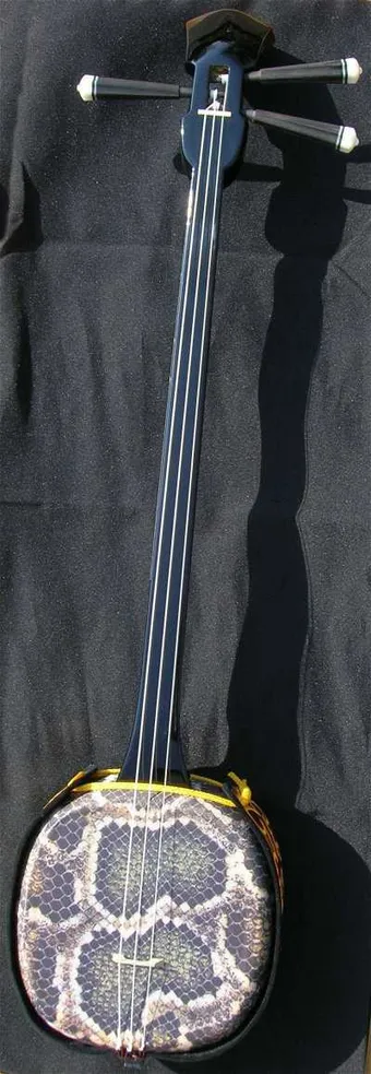 The sanshin is a traditional Okinawan musical instrument with three strings stretched over a body historically covered with snakeskin. Closely tied to local music and songs, it holds a central place in Okinawan culture, symbolizing identity, cultural transmission, and a strong sense of community.