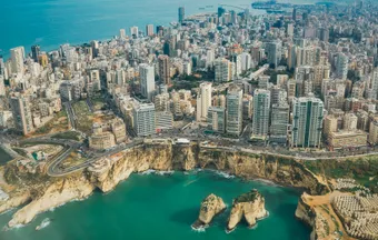 Aerial view of Beirut along the Mediterranean coast, featuring the Corniche, coastal cliffs, and the Raouche Rocks