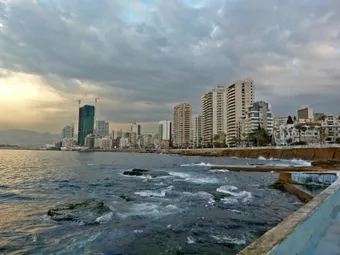 The Beirut Corniche, seen from the university tower, offers a stunning panoramic view of the Mediterranean Sea. This iconic seaside promenade highlights the contrast between the coastline, the Raouché cliffs, and the vibrant urban life of Beirut.