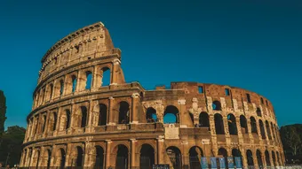 Stunning view of the ancient Roman Colosseum, captured at sunset showcasing its historic arches.