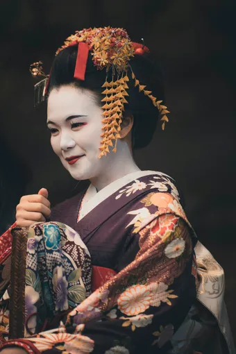 A geisha is a Japanese artist trained in traditional arts such as dance, music, and conversation.She represents elegance, culture, and refinement in Japan.
