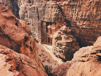 High-angle view of Petra’s Treasury carved into pink sandstone cliffs