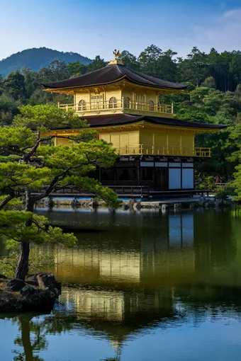 Kinkaku-ji is a Buddhist temple famous for its golden pavilion shining above the water. It is remarkable for its beauty and the perfect balance between architecture and nature.