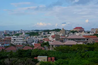 Panoramic view of Okinawa cityscape with traditional and modern buildings.