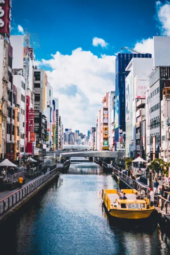 Central Osaka is lively and modern, with canals running between colorful buildings. The Dōtonbori area is famous for its vibrant atmosphere, restaurants, and waterside walks.