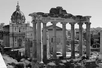 Black and white photo of ancient Roman Forum ruins with church