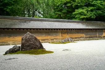 A zen garden is a space designed to promote calm, contemplation, and harmony with nature. It uses simple elements such as water, stones, and plants to create a peaceful atmosphere.