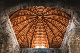 A stunning architectural detail of the wooden dome inside the Umayyad Palace, Amman, Jordan.